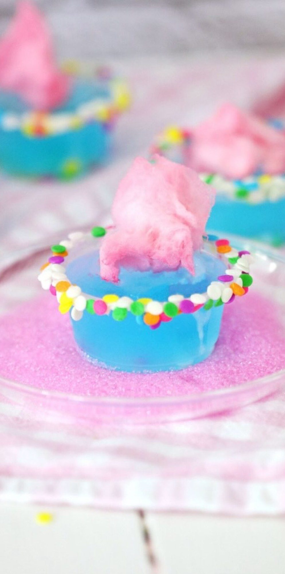 Blue Dream Cake topped with pink cotton candy and colorful sprinkles