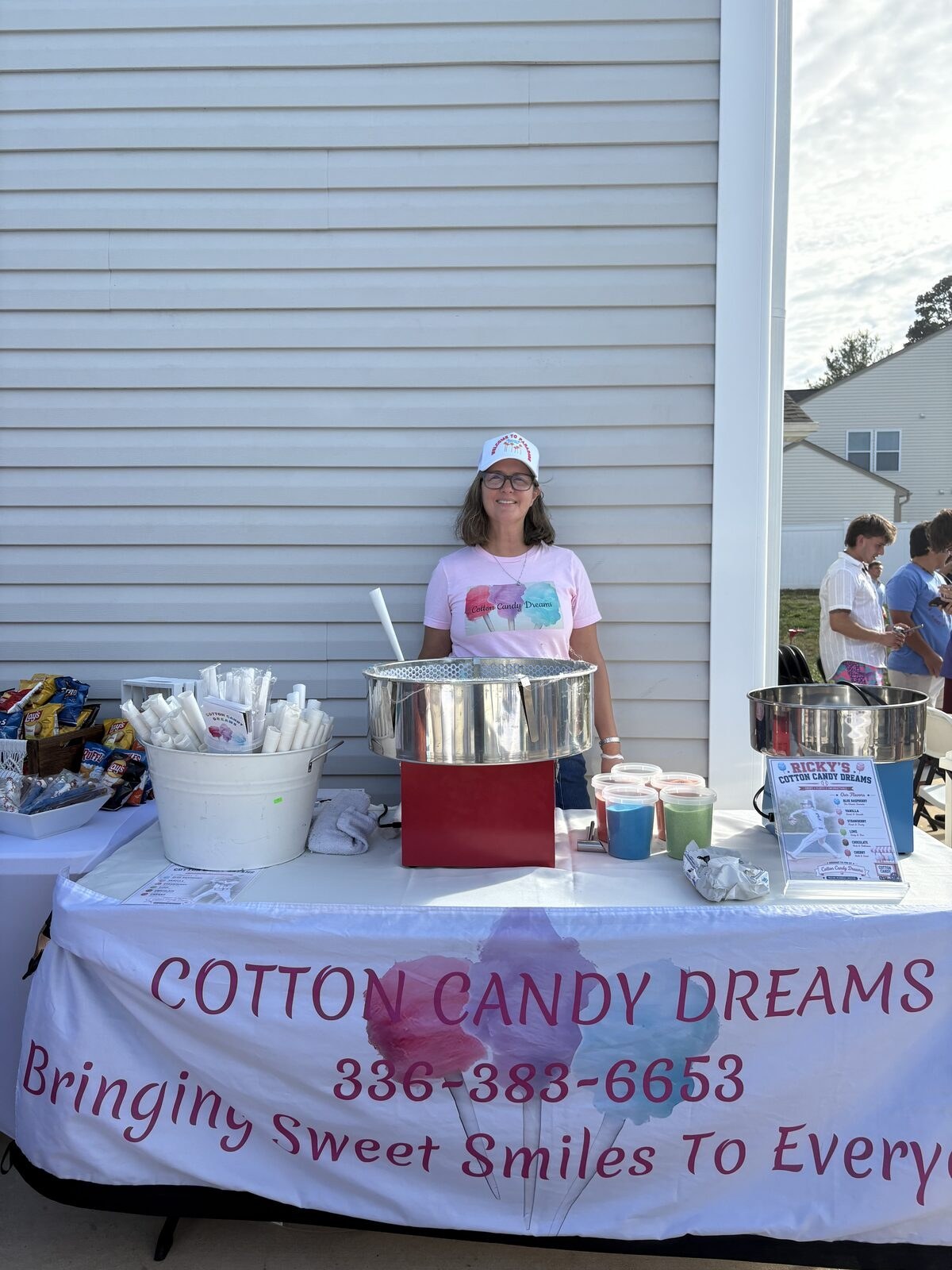 Carol Greve serving cotton candy at a neighborhood event booth
