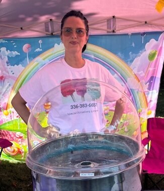 Carol Greve welcoming guests at a Cotton Candy Dreams outdoor event booth