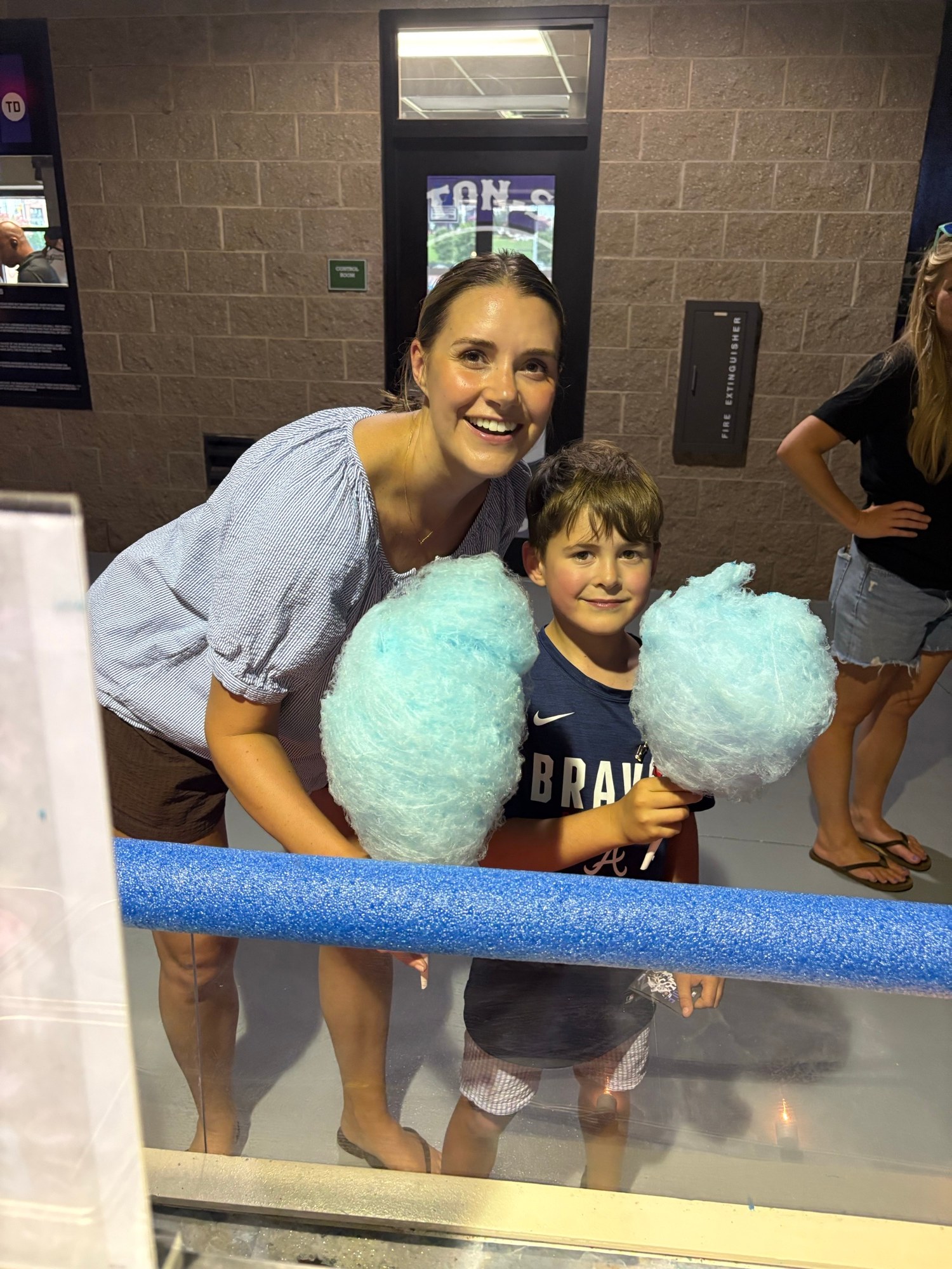 Family enjoying fresh blue cotton candy at a Winston-Salem Dash game