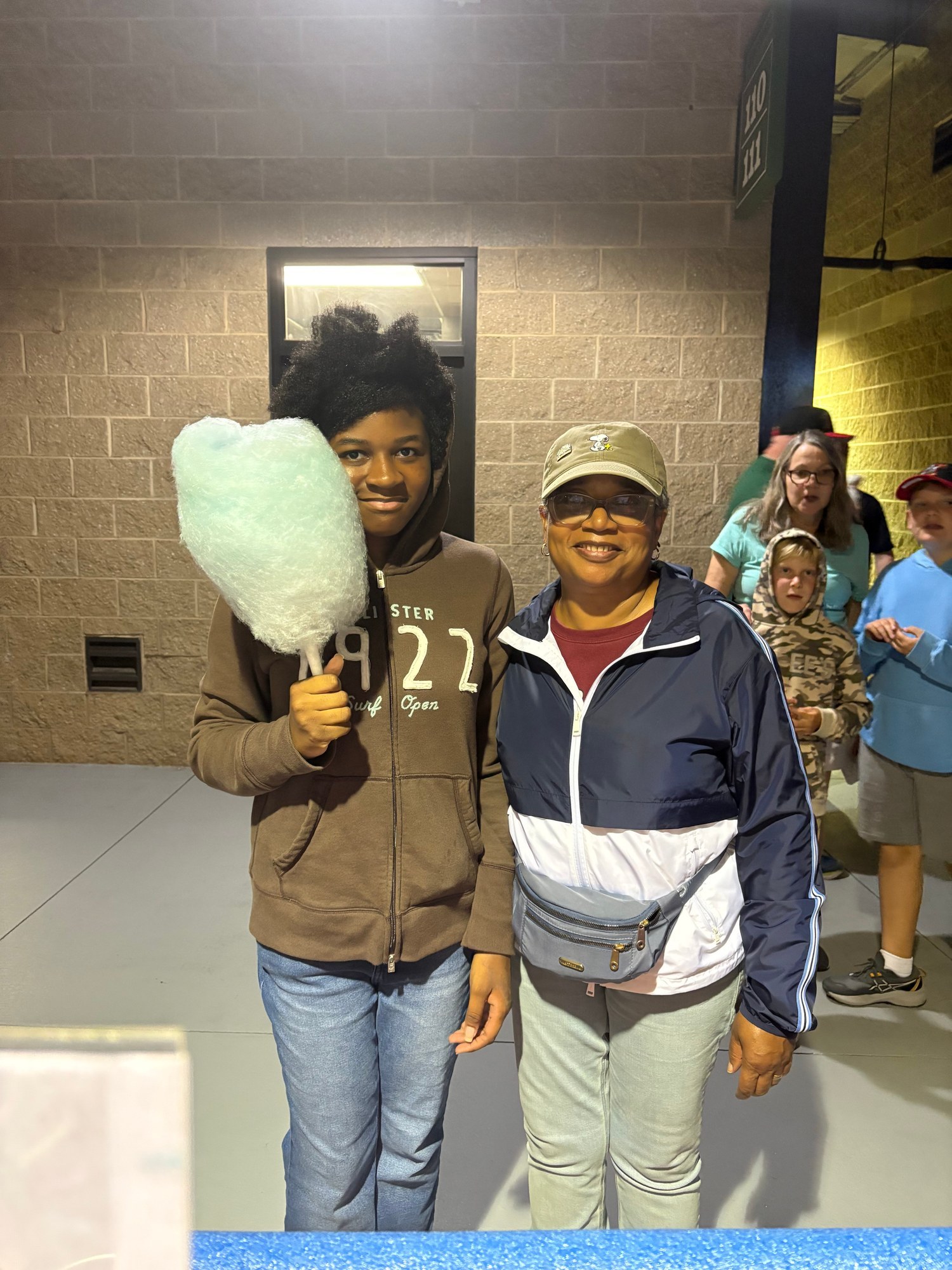 Family enjoying fresh mint cotton candy at a Winston-Salem Dash game