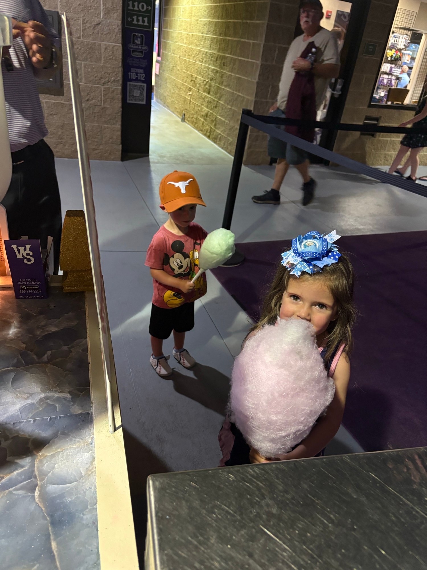 Young guest enjoying pink cotton candy at a Winston-Salem Dash game