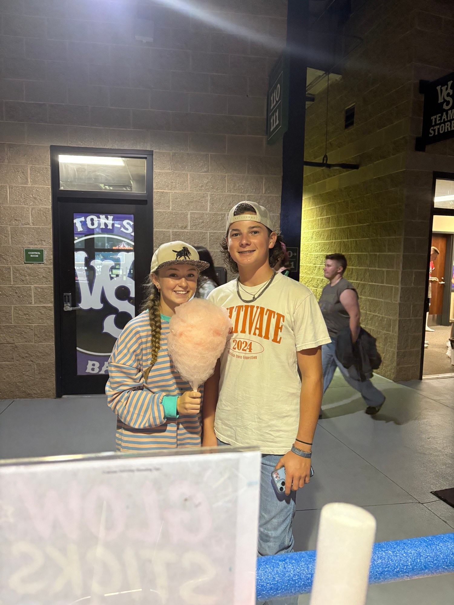 Young guests enjoying pink cotton candy at a Winston-Salem Dash game