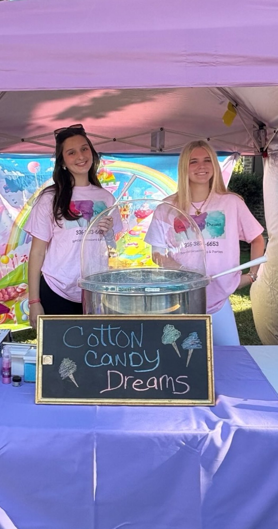 Cotton Candy Dreams event team welcoming guests at an outdoor booth