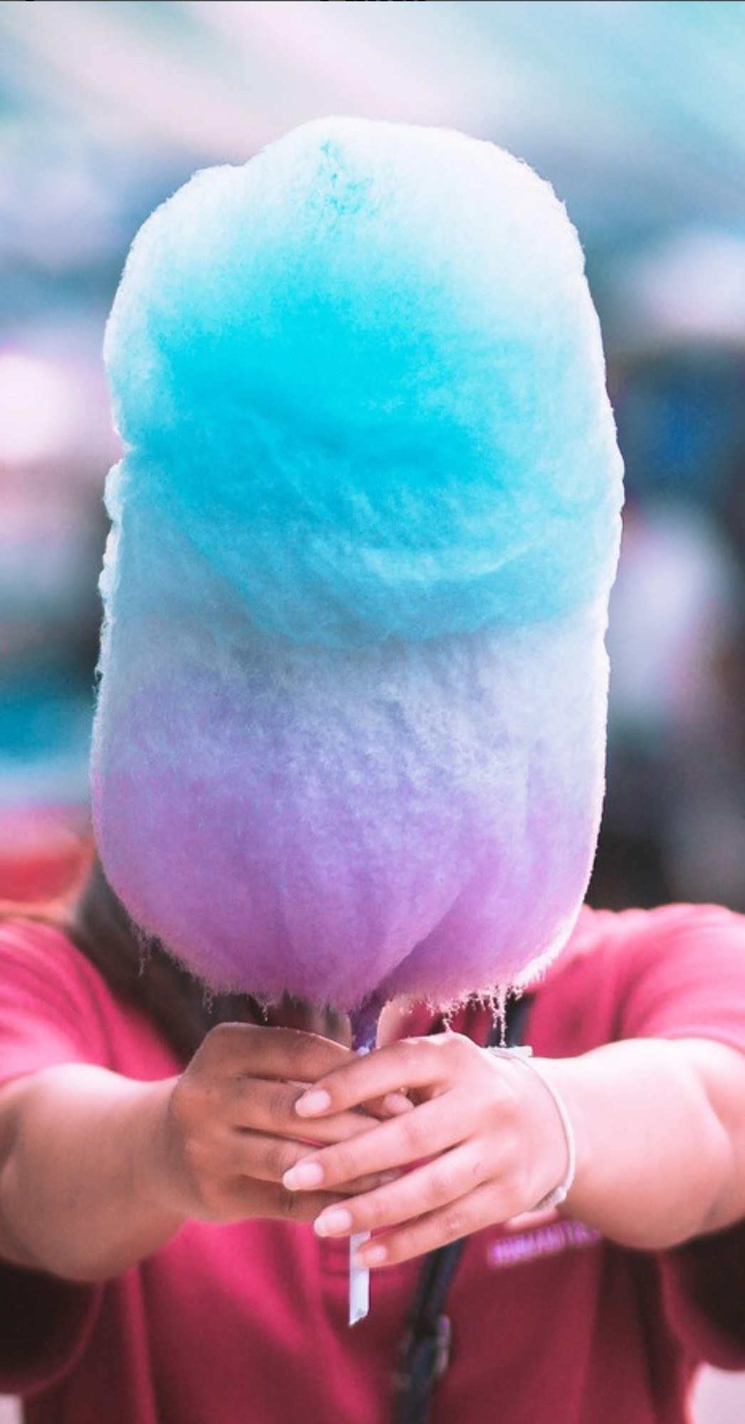 Guest enjoying a giant blue and purple cotton candy creation
