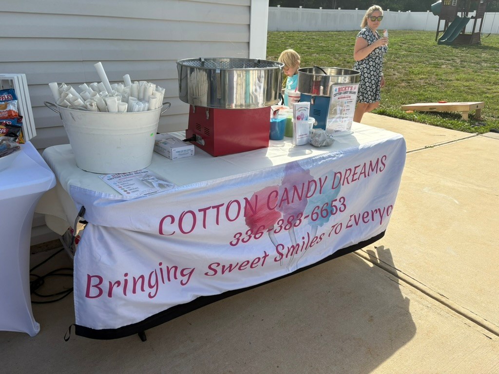 Cotton Candy Dreams spinning station set up for an outdoor celebration
