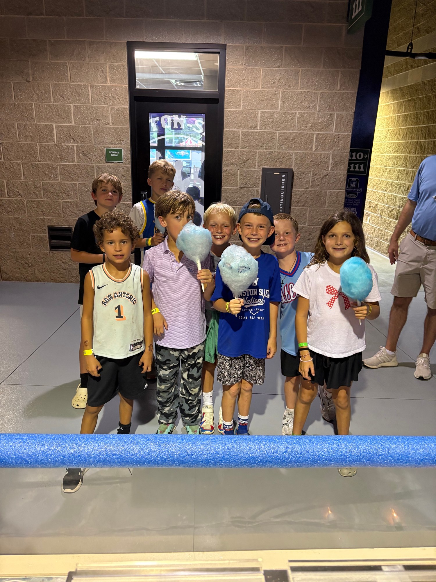 Young guests enjoying fresh cotton candy at a Winston-Salem Dash game