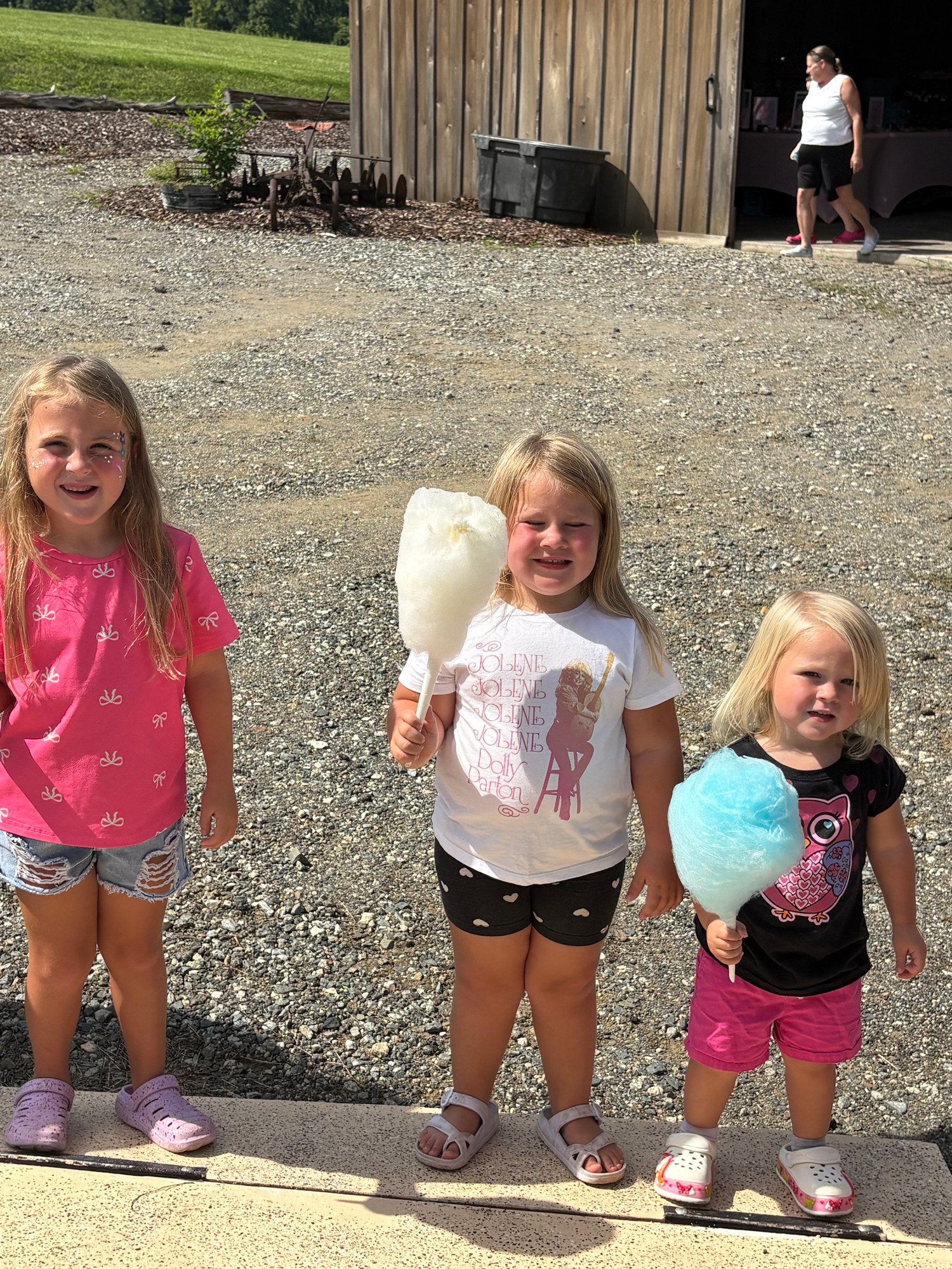 Young guests enjoying cotton candy at a summer community event