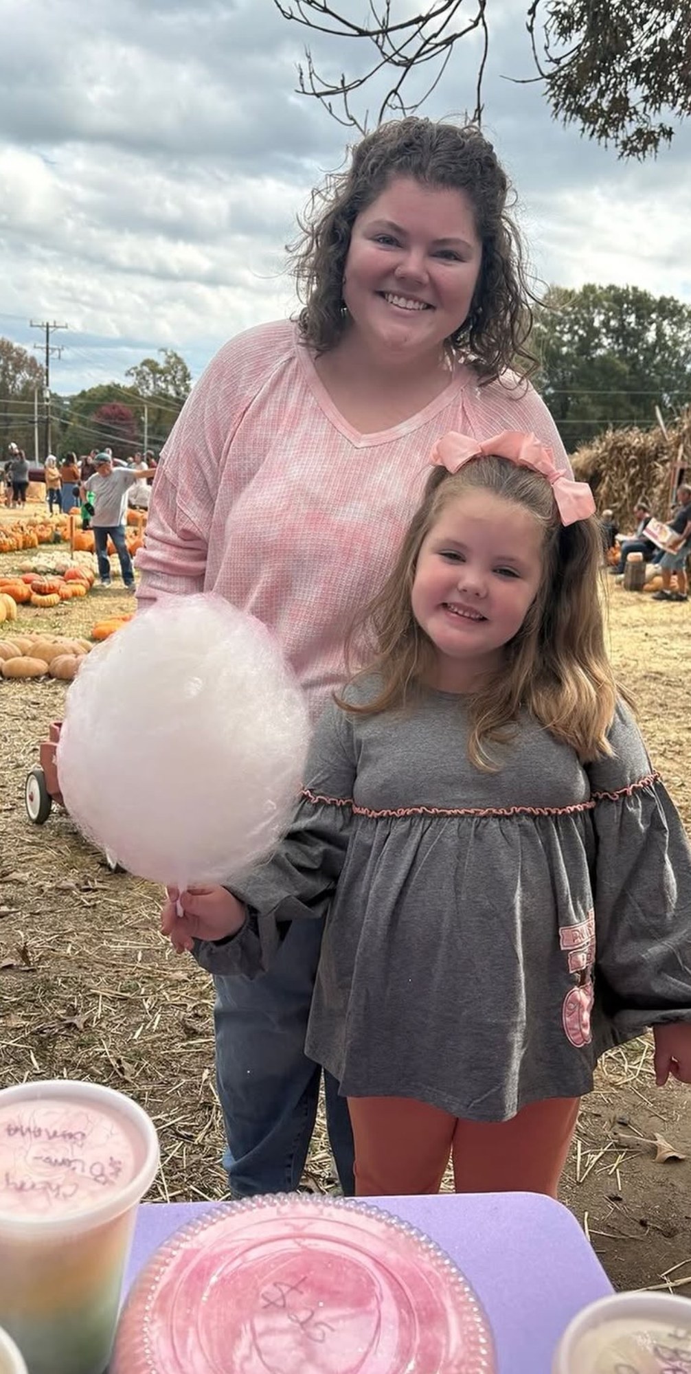 A family enjoying fresh cotton candy at the pumpkin patch