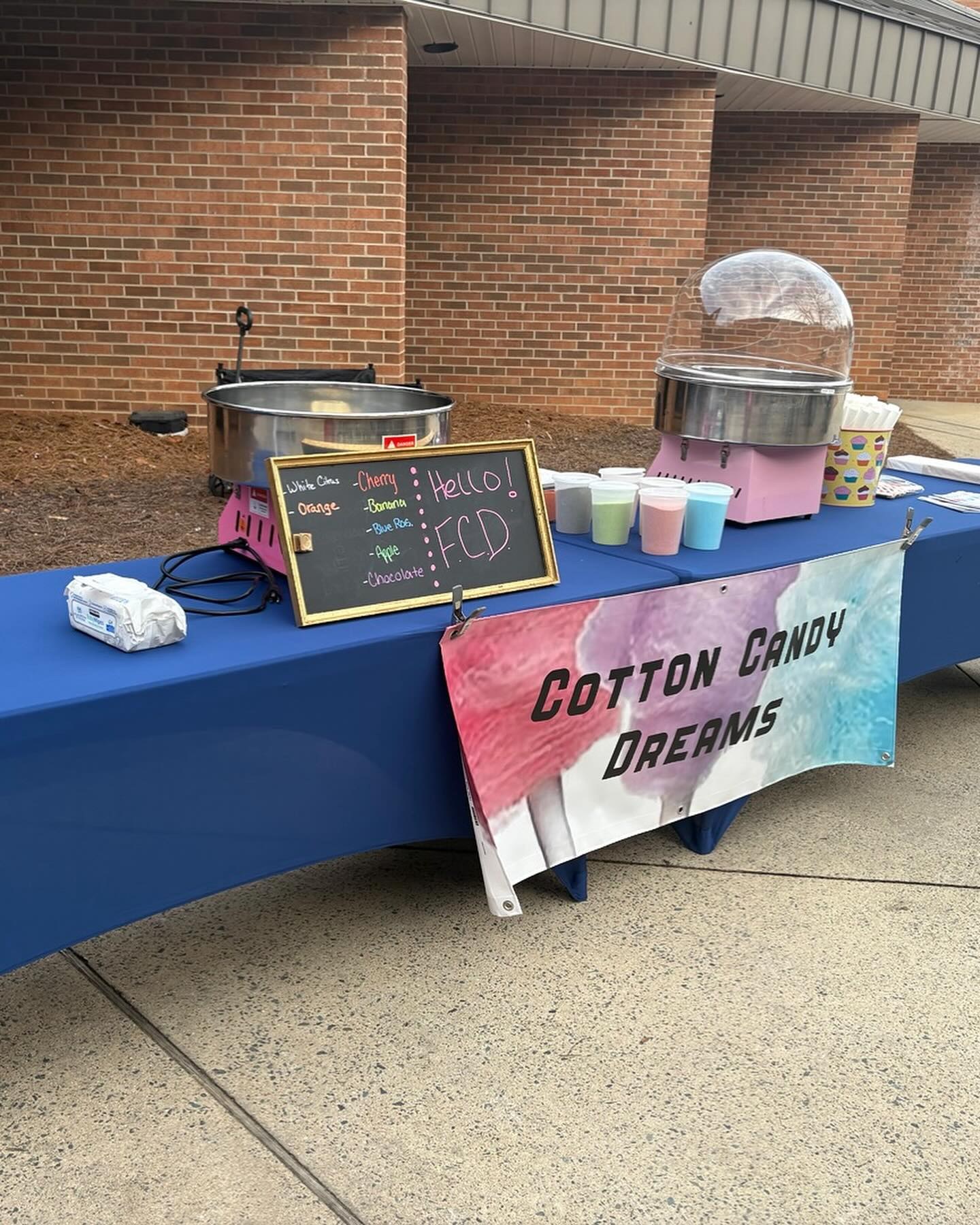 Cotton Candy Dreams branded booth and machines at a school arts event